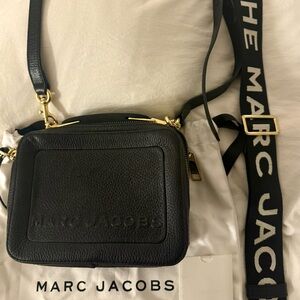 Marc Jacob’s black camera bag with added strap